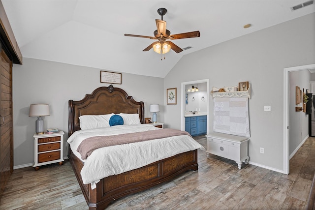 bedroom featuring lofted ceiling, a ceiling fan, visible vents, and wood finished floors