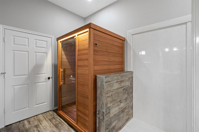 bathroom featuring a sauna, a shower, and wood finished floors