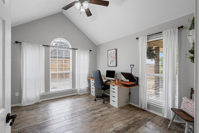office space with wood finished floors, ceiling fan, and high vaulted ceiling