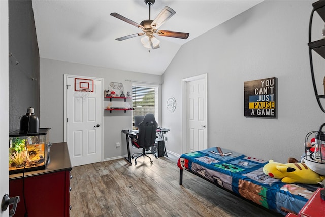 bedroom with lofted ceiling, baseboards, ceiling fan, and wood finished floors