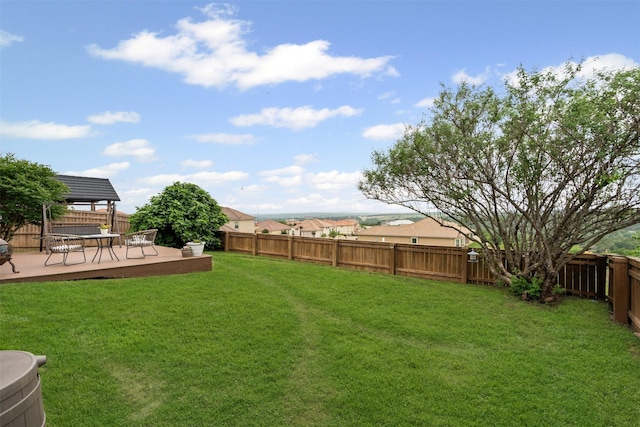 view of yard featuring a gazebo, a deck, and a fenced backyard