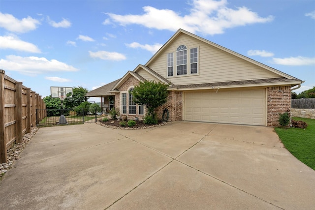 view of front of home with concrete driveway, brick siding, an attached garage, and fence