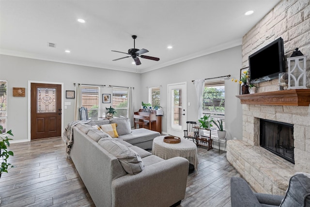 living room featuring a ceiling fan, recessed lighting, a fireplace, and visible vents