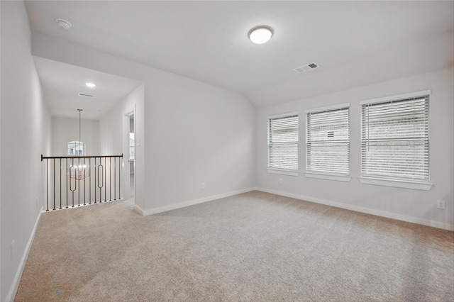carpeted spare room with visible vents and baseboards