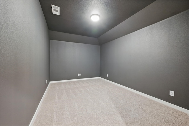 additional living space featuring baseboards, visible vents, carpet, and vaulted ceiling