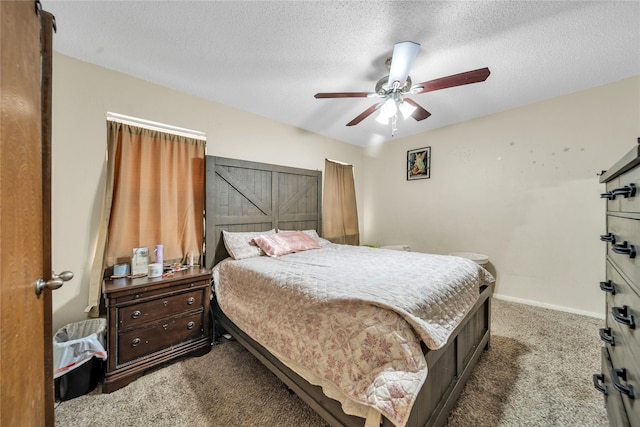 bedroom with ceiling fan, a textured ceiling, carpet floors, and baseboards