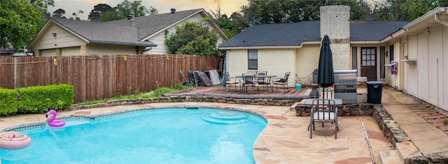 view of pool featuring a patio area, fence, and a fenced in pool