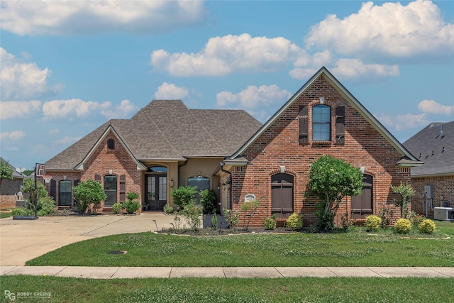 230 Welham Trce, Bossier City, LA 71112 - view of front of property with a shingled roof, brick siding, and a front lawn