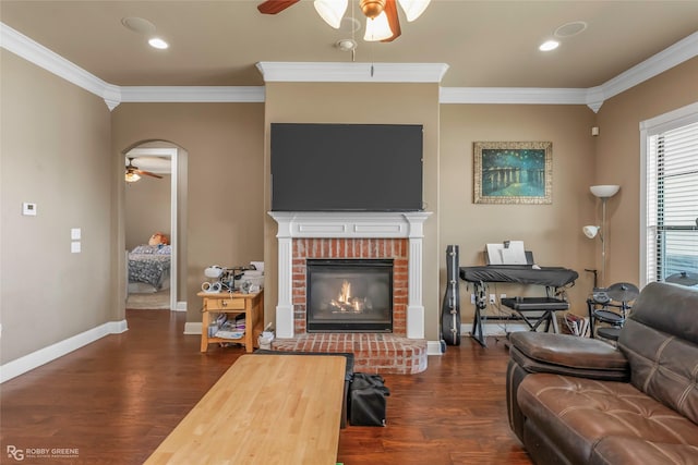 230 Welham Trce, Bossier City, LA 71112 - living room featuring a fireplace, ceiling fan, crown molding, and dark wood-type flooring