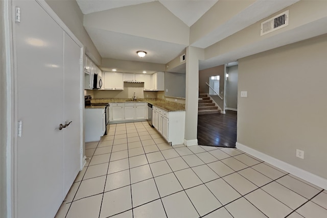 kitchen featuring a sink, visible vents, white cabinetry, baseboards, and appliances with stainless steel finishes
