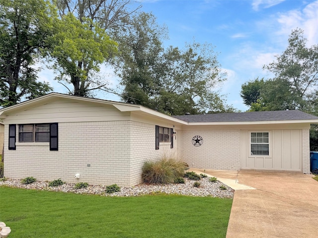 ranch-style home with a front lawn, board and batten siding, and brick siding