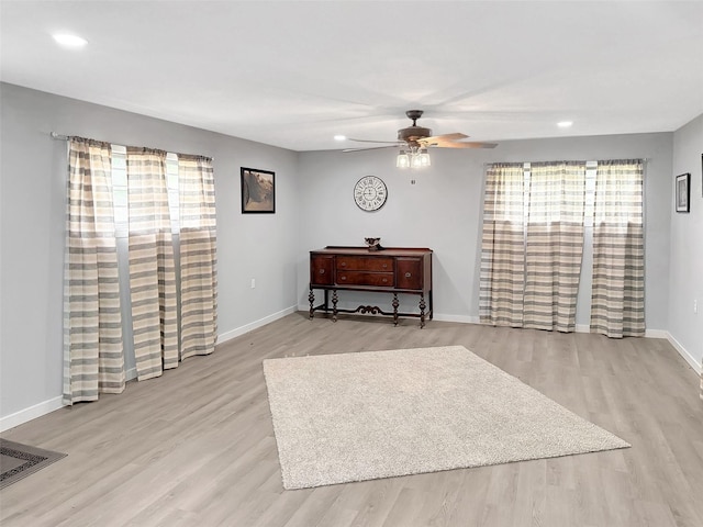 interior space with a wealth of natural light, recessed lighting, ceiling fan, and wood finished floors