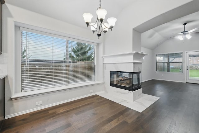 unfurnished living room featuring wood finished floors, ceiling fan with notable chandelier, a tiled fireplace, baseboards, and lofted ceiling