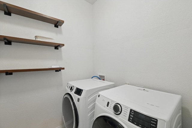 laundry room featuring washer and clothes dryer, laundry area, and baseboards