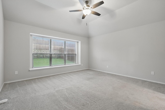 carpeted empty room with baseboards, ceiling fan, and vaulted ceiling