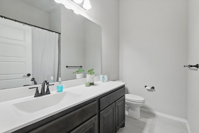 bathroom with vanity, toilet, baseboards, and tile patterned flooring