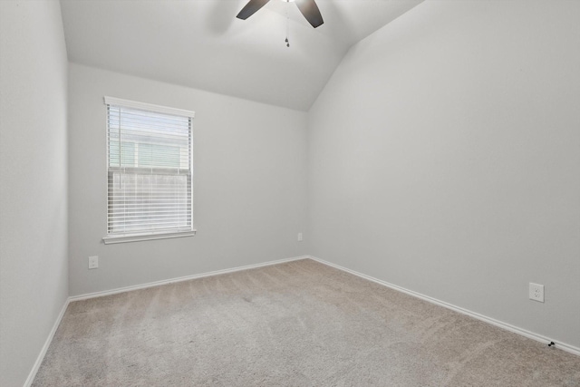 spare room featuring vaulted ceiling, baseboards, ceiling fan, and carpet floors