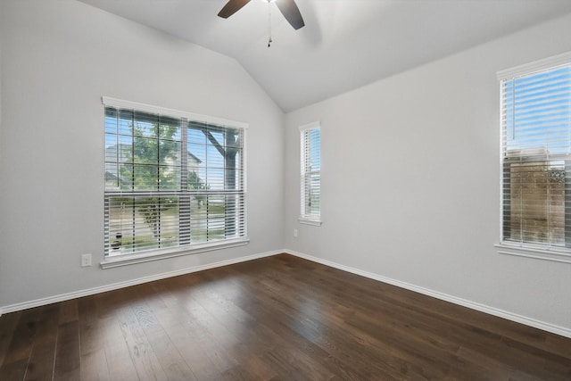 unfurnished room with vaulted ceiling, dark wood-style flooring, baseboards, and a ceiling fan