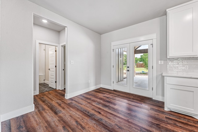 1007 Westwood, Graham, TX 76450 - doorway to outside with dark wood-style flooring and baseboards