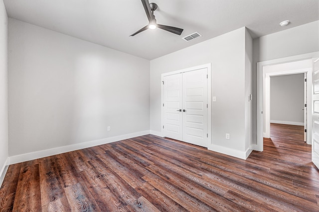 1007 Westwood, Graham, TX 76450 - unfurnished bedroom featuring wood finished floors, a closet, visible vents, baseboards, and ceiling fan