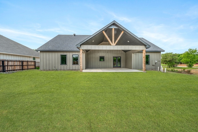 1007 Westwood, Graham, TX 76450 - rear view of property with a lawn, board and batten siding, french doors, fence, and a patio area