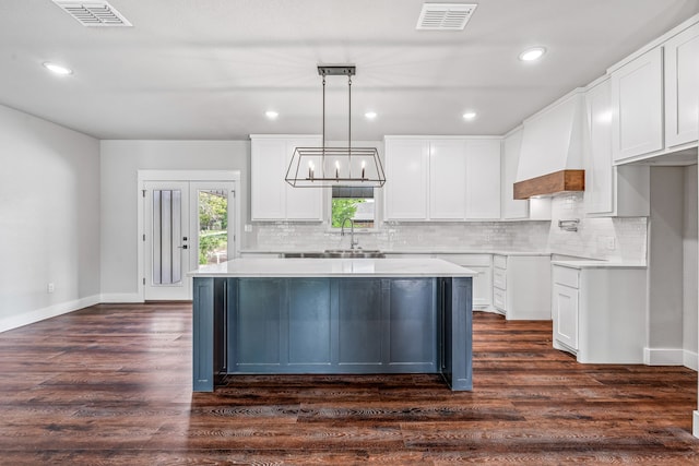 1007 Westwood, Graham, TX 76450 - kitchen with backsplash, dark wood finished floors, and visible vents