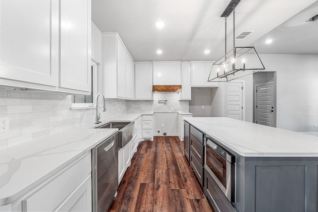 1007 Westwood, Graham, TX 76450 - kitchen featuring a sink, recessed lighting, white cabinetry, dark wood-style floors, and appliances with stainless steel finishes