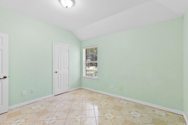 908 E Belknap St, Ennis, TX 75119 - unfurnished room featuring lofted ceiling, baseboards, and light tile patterned floors