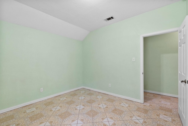 908 E Belknap St, Ennis, TX 75119 - spare room featuring lofted ceiling and baseboards