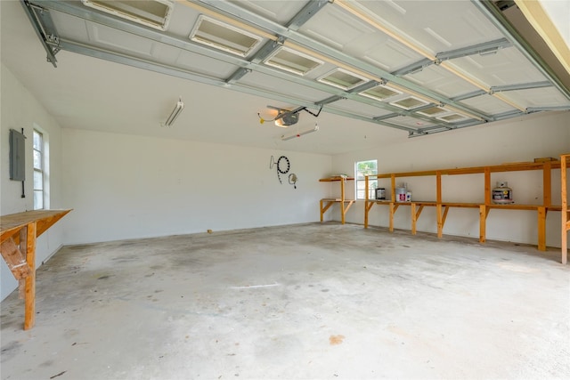 garage with electric panel and a garage door opener