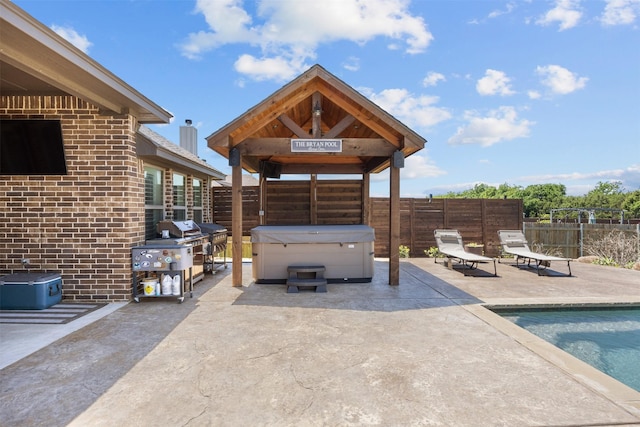 view of patio / terrace featuring an outdoor pool, a gazebo, a hot tub, and a fenced backyard