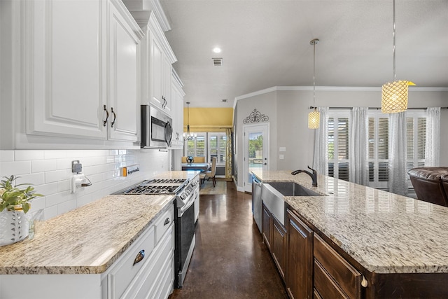 kitchen with a sink, dark brown cabinetry, white cabinetry, appliances with stainless steel finishes, and decorative backsplash