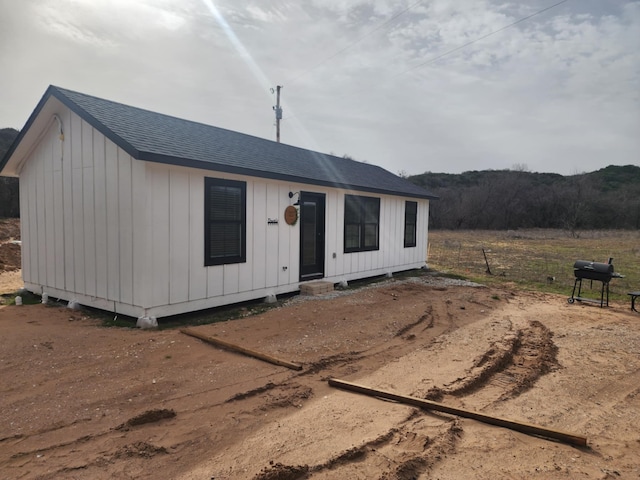 view of front of home with a shingled roof