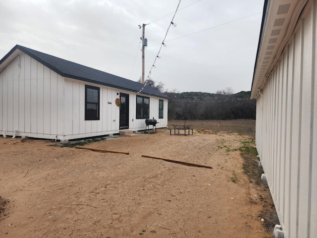 rear view of property with board and batten siding