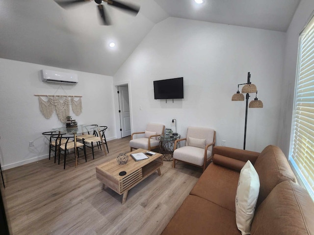 living room with a ceiling fan, high vaulted ceiling, light wood-type flooring, baseboards, and an AC wall unit