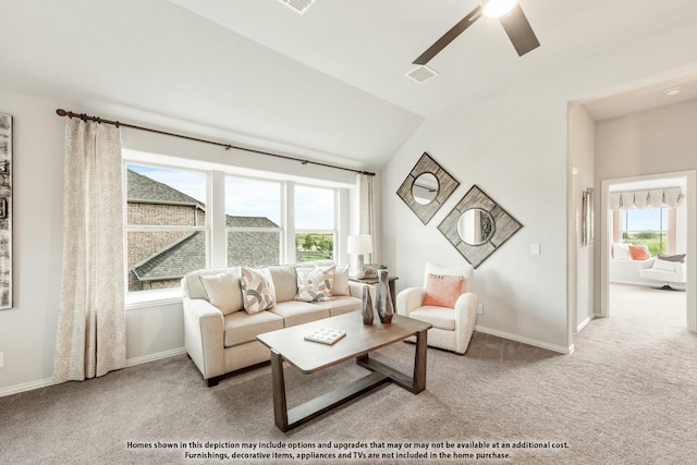 carpeted living room featuring vaulted ceiling, ceiling fan, and baseboards