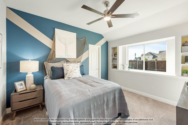 carpeted bedroom with lofted ceiling, baseboards, and a ceiling fan
