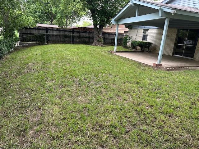 view of yard featuring a patio area and fence