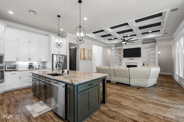 kitchen featuring a sink, ceiling fan with notable chandelier, visible vents, crown molding, and appliances with stainless steel finishes