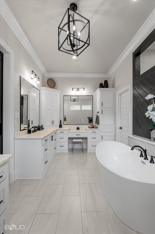 full bath with vanity, ornamental molding, a notable chandelier, and a soaking tub