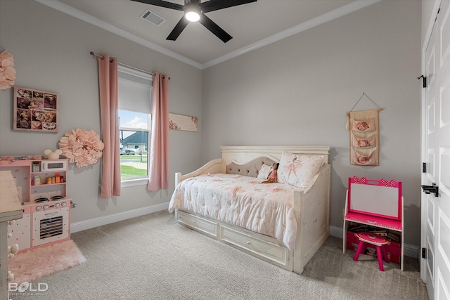carpeted bedroom featuring baseboards, crown molding, visible vents, and a ceiling fan