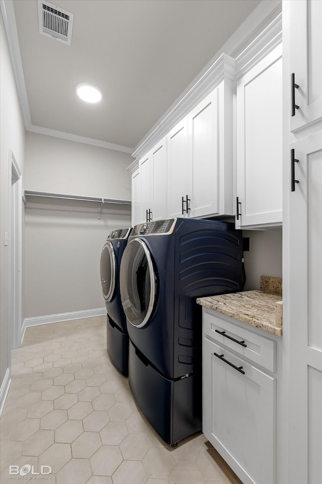 washroom with cabinet space, washer and clothes dryer, visible vents, baseboards, and ornamental molding