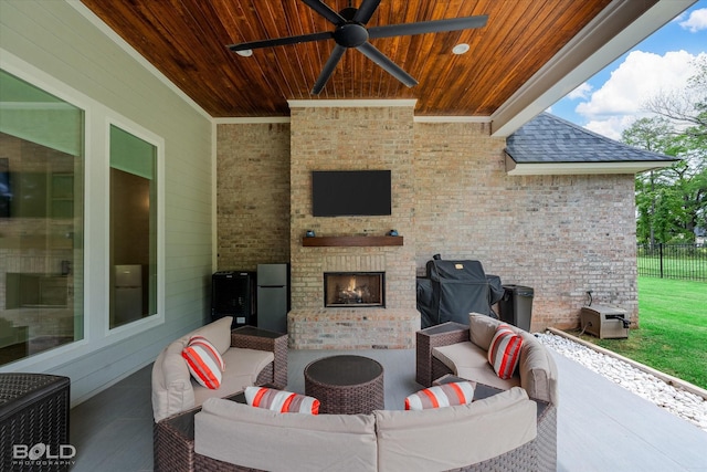 view of patio featuring an outdoor living space with a fireplace, fence, a ceiling fan, and grilling area