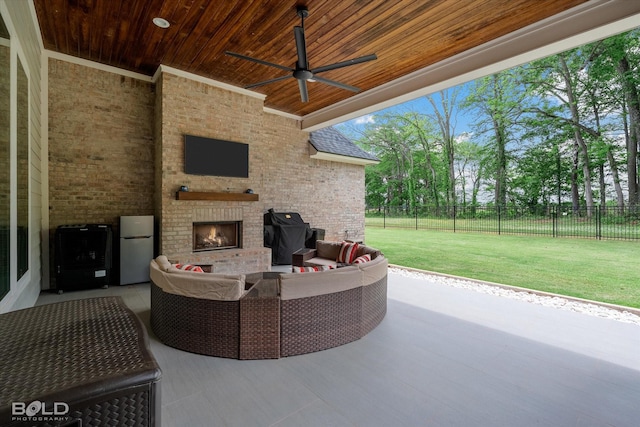 view of patio with area for grilling, an outdoor living space with a fireplace, fence, and ceiling fan