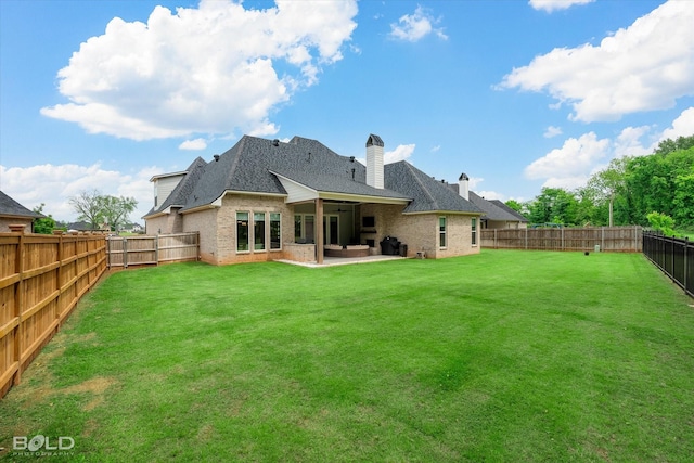 back of house featuring a lawn, brick siding, a patio area, a shingled roof, and a fenced backyard