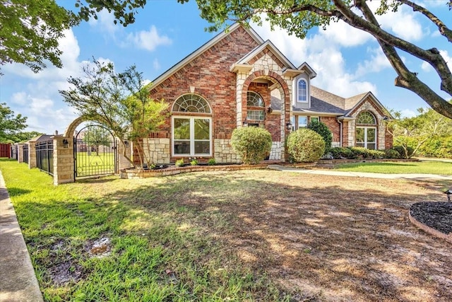 188 Jordan Ct, Lucas, TX 75002 - traditional home with a gate, stone siding, and brick siding