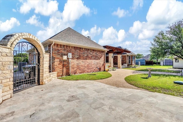 188 Jordan Ct, Lucas, TX 75002 - view of front facade featuring a gate, a front yard, brick siding, and a shingled roof