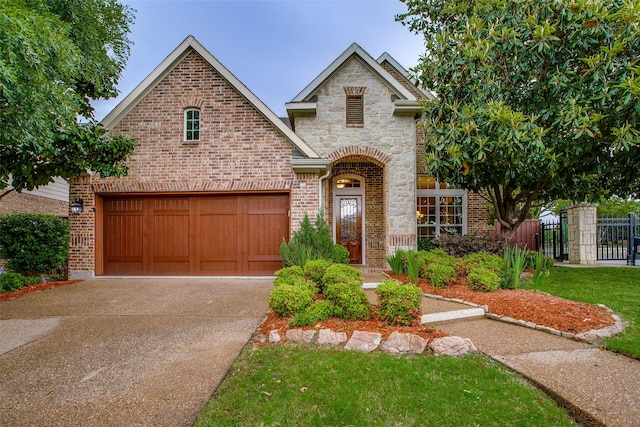 10853 Dixon Branch Dr, Dallas, TX 75218 - view of front of property featuring concrete driveway, brick siding, fence, and a garage