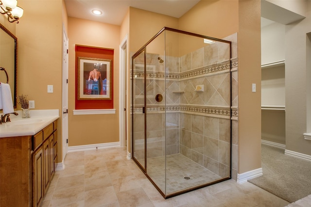 10853 Dixon Branch Dr, Dallas, TX 75218 - bathroom featuring a walk in closet, vanity, baseboards, and a shower stall