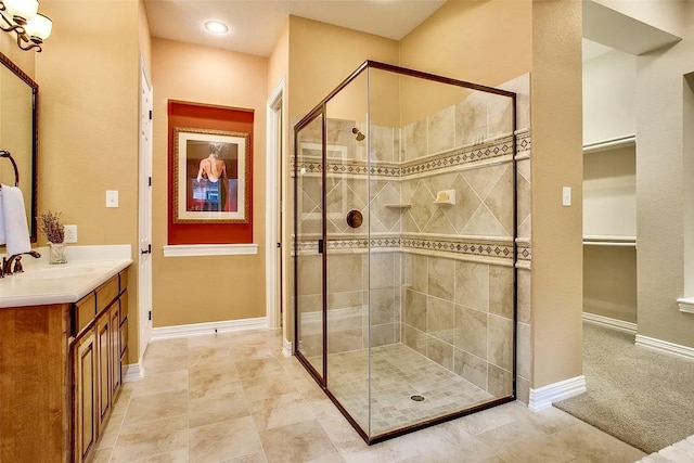 10853 Dixon Branch Dr, Dallas, TX 75218 - full bath with a shower stall, vanity, a walk in closet, and baseboards